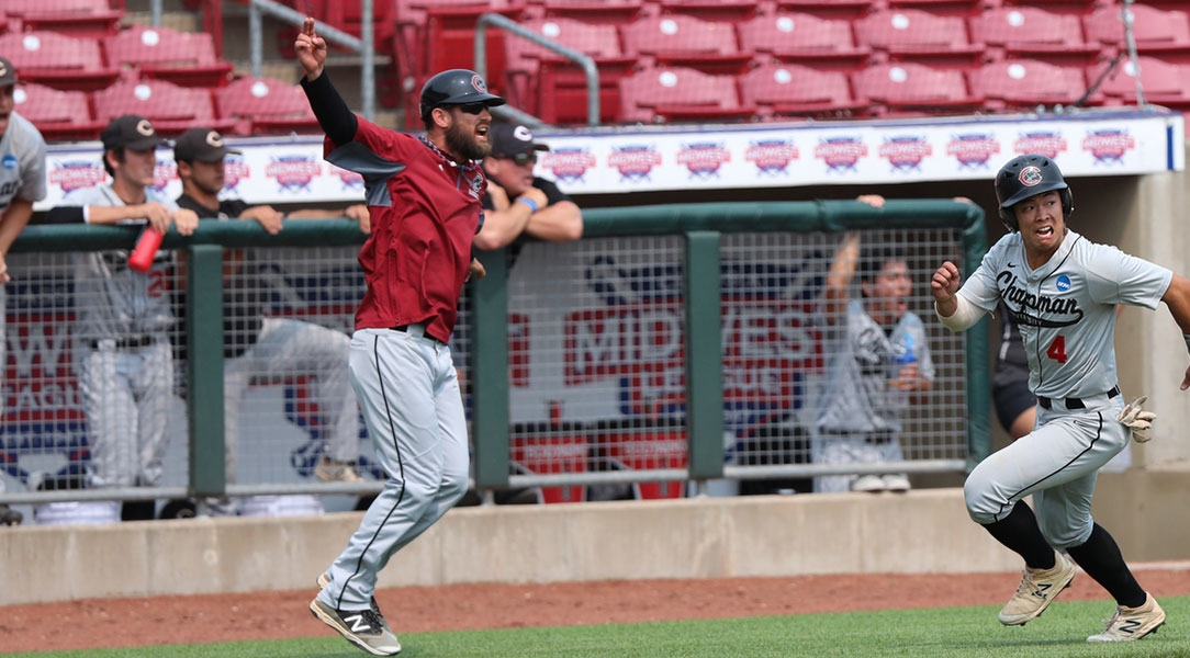 Coach Fox waves Alex Tsuruda around third base to score.