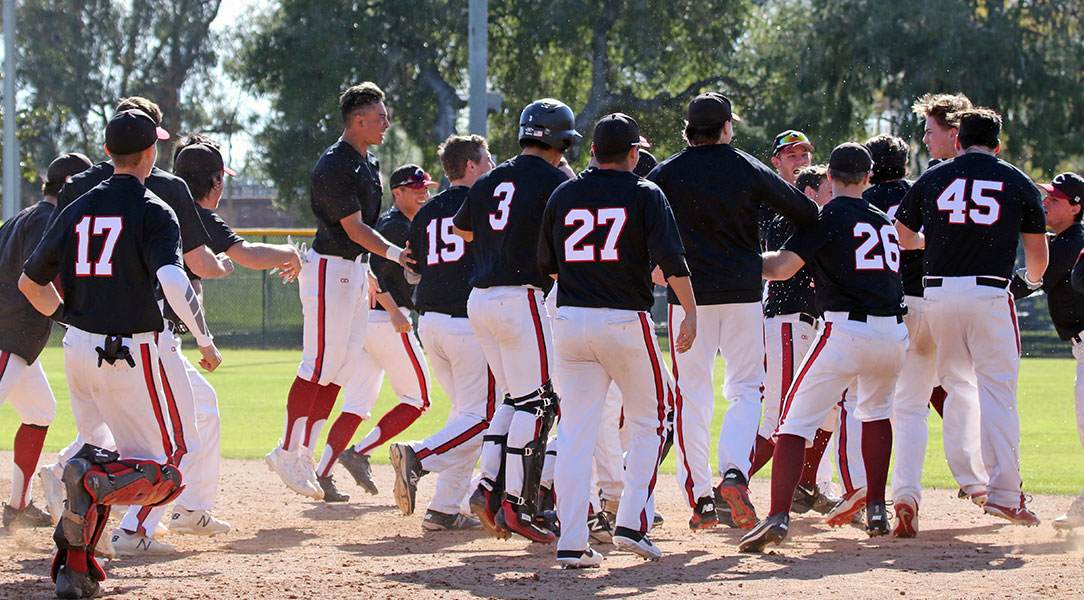 The baseball team celebrates a walk-off victory.