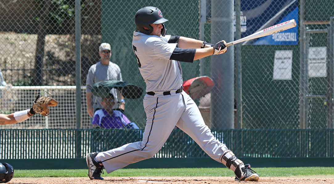 Mack Cheli swings a baseball bat.