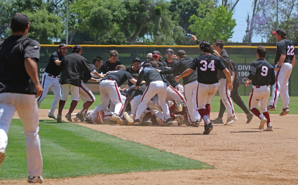 The baseball team dogpiles after the winning run.