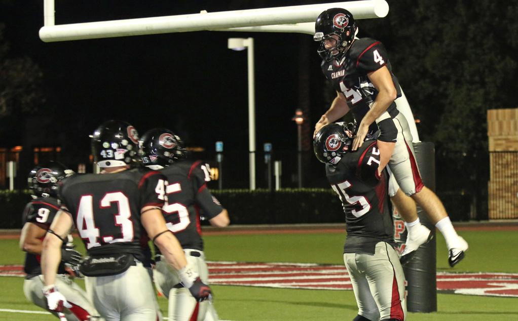 Michael Lahey (right) celebrates with teammates after a touchdown catch vs. La Verne (Larry Newman Photography)