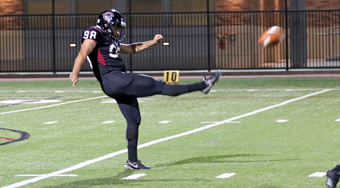 Elias Deeb punts the ball.