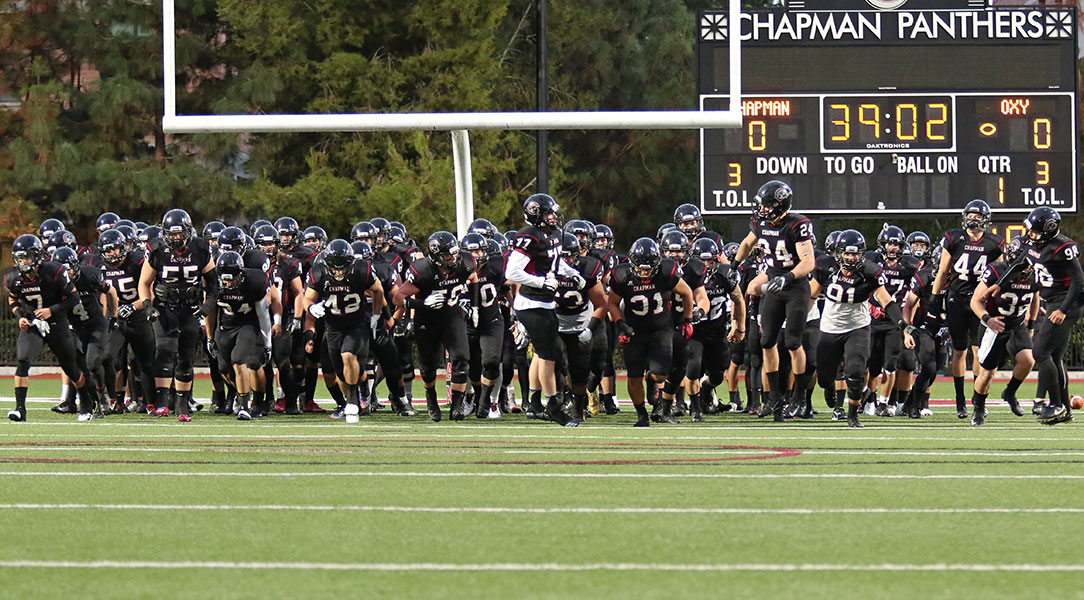 The football team runs out of the end zone