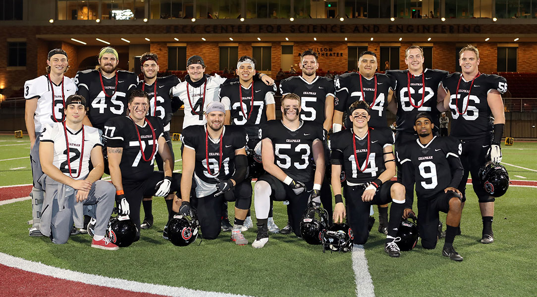 The 2019 Chapman football seniors pose while being honored on Senior Night.
