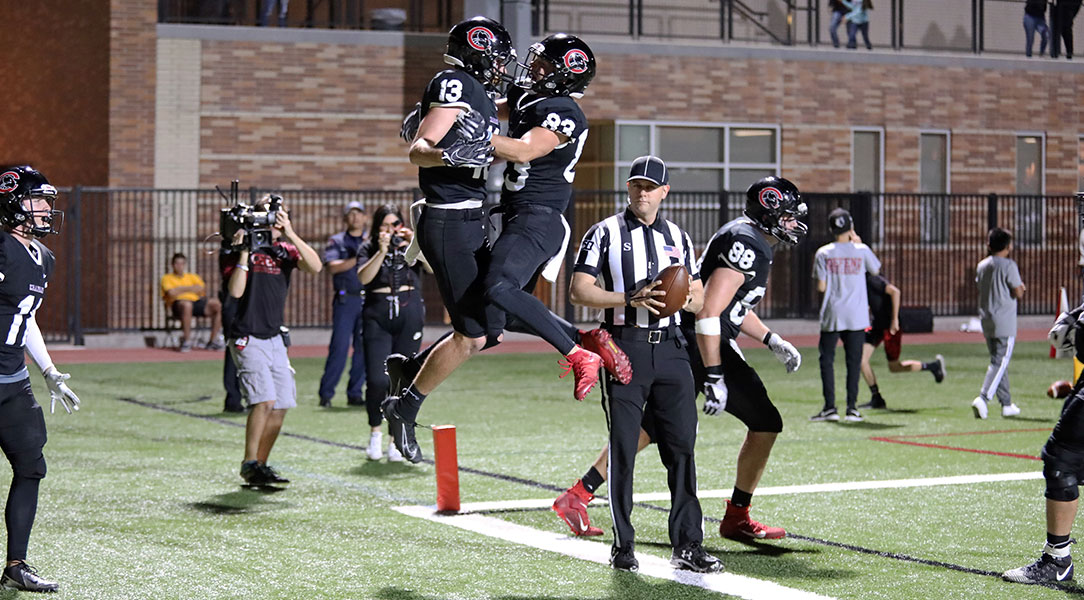 Spencer Corona and Wyatt Hardin celebrate Corona's touchdown.