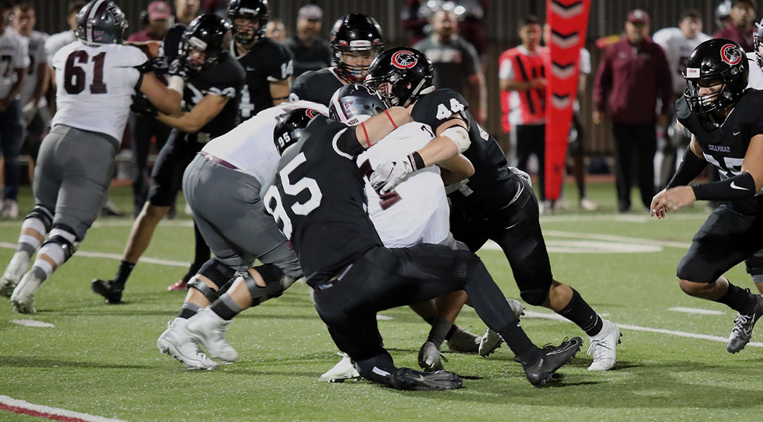 Dillon Keefe and Vinny Caffaro tackle a player from Redlands.