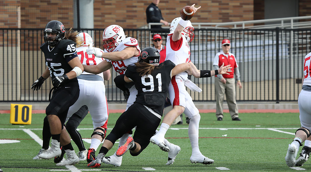 Ricky Madeiros takes down the quarterback in one of his three sacks of the game.
