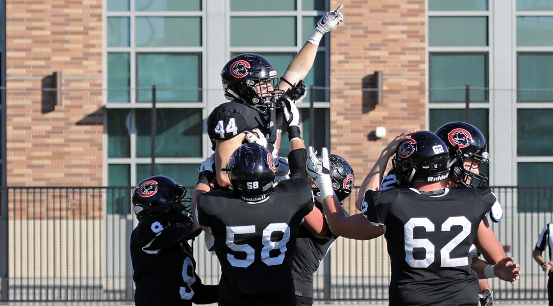 Teammates lift Dillon Keefe after a touchdown.