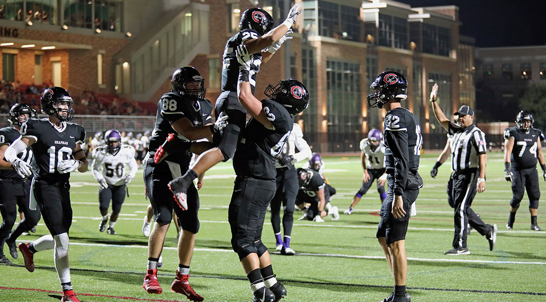 Jacob Wilbanks hold up Marcos Reyes to celebrate a TD.