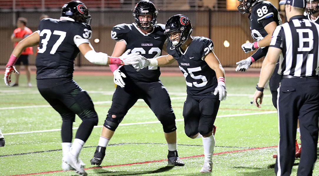 Marcos Reyes is congratulated by teammates after a touchdown.