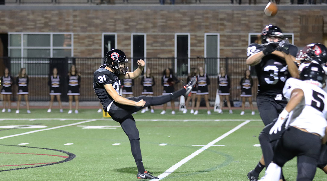 Owen Tapia punts the ball.