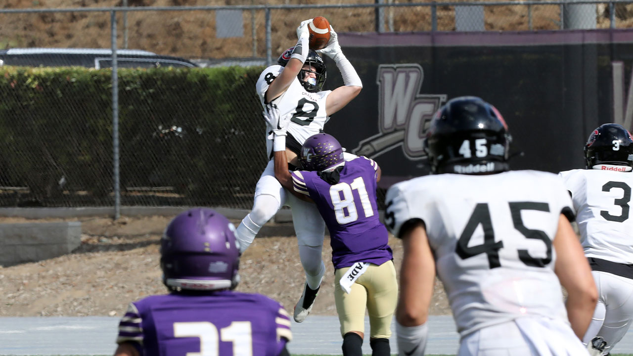 Adam Andrade jumps over another player and catches an interception.