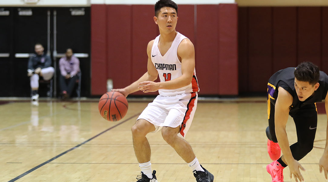 Reed Nakakihara beats his defender while dribbling the ball.