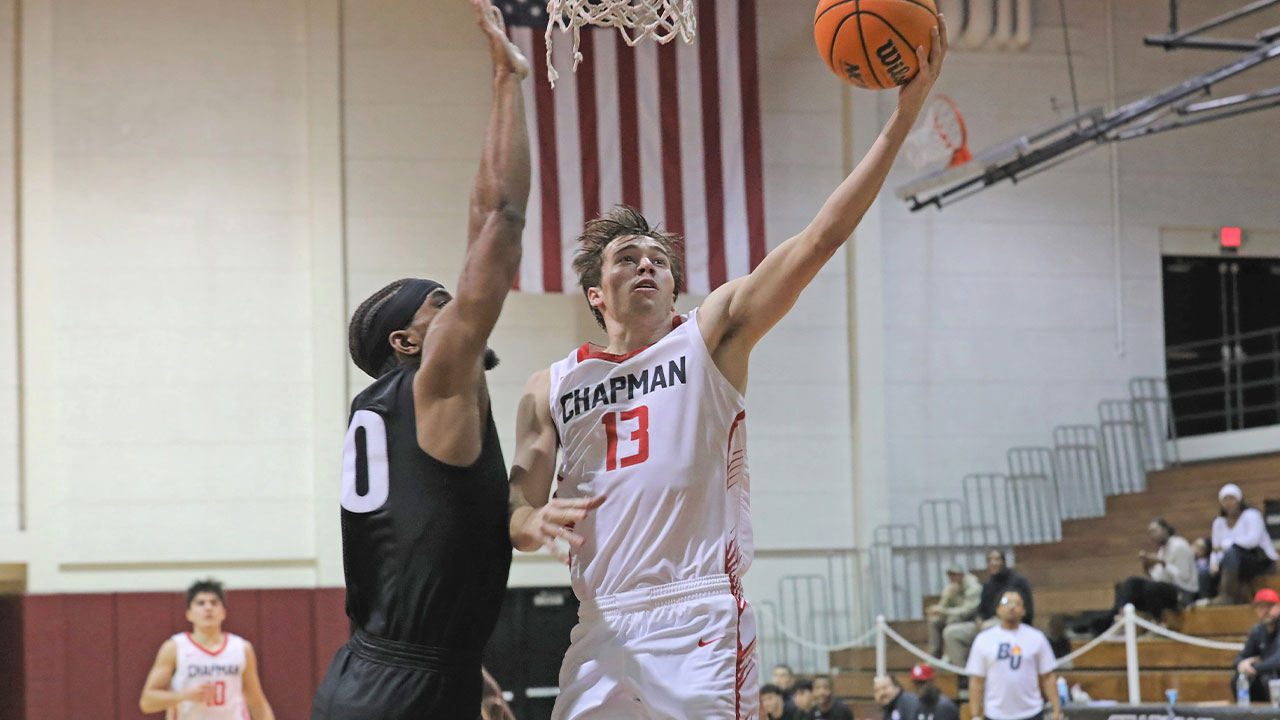 Jake Heberle shoots a layup with his left hand around a defender.