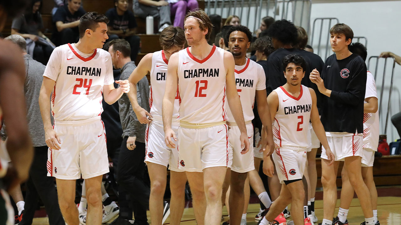 Chapman players walk on to the basketball court to start the game.