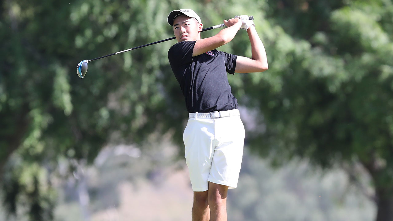 Bradley Lu watches his golf shot.