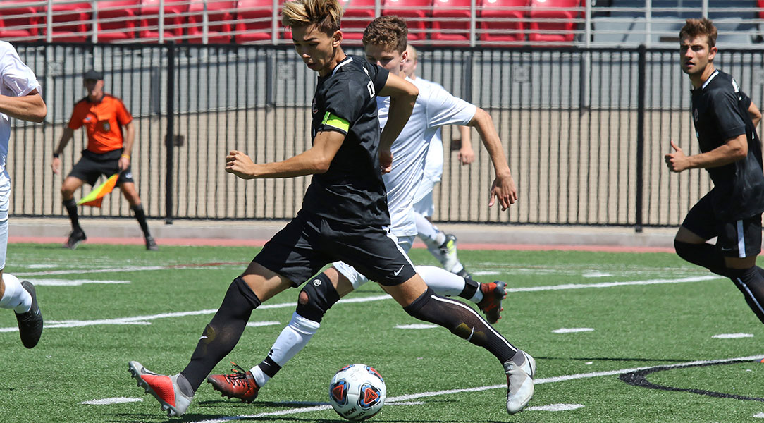 Kai Howe keeps the ball away from a defender.
