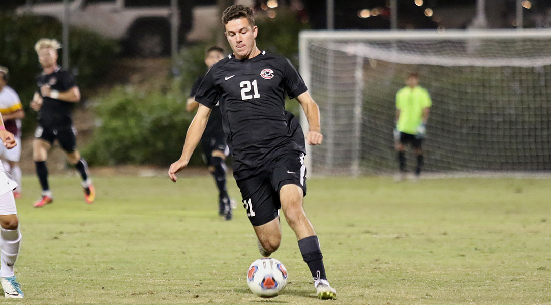 Aidan Wall dribbles the ball.