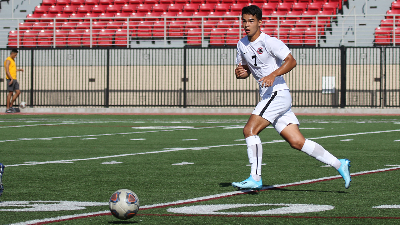 Tobi Howe kicks the soccer ball 