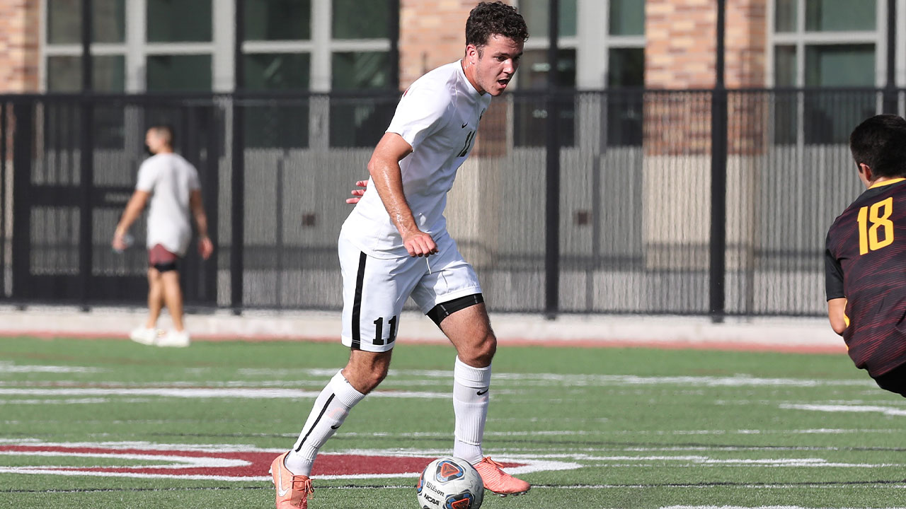 Aidan Wall dribbles around a defender.
