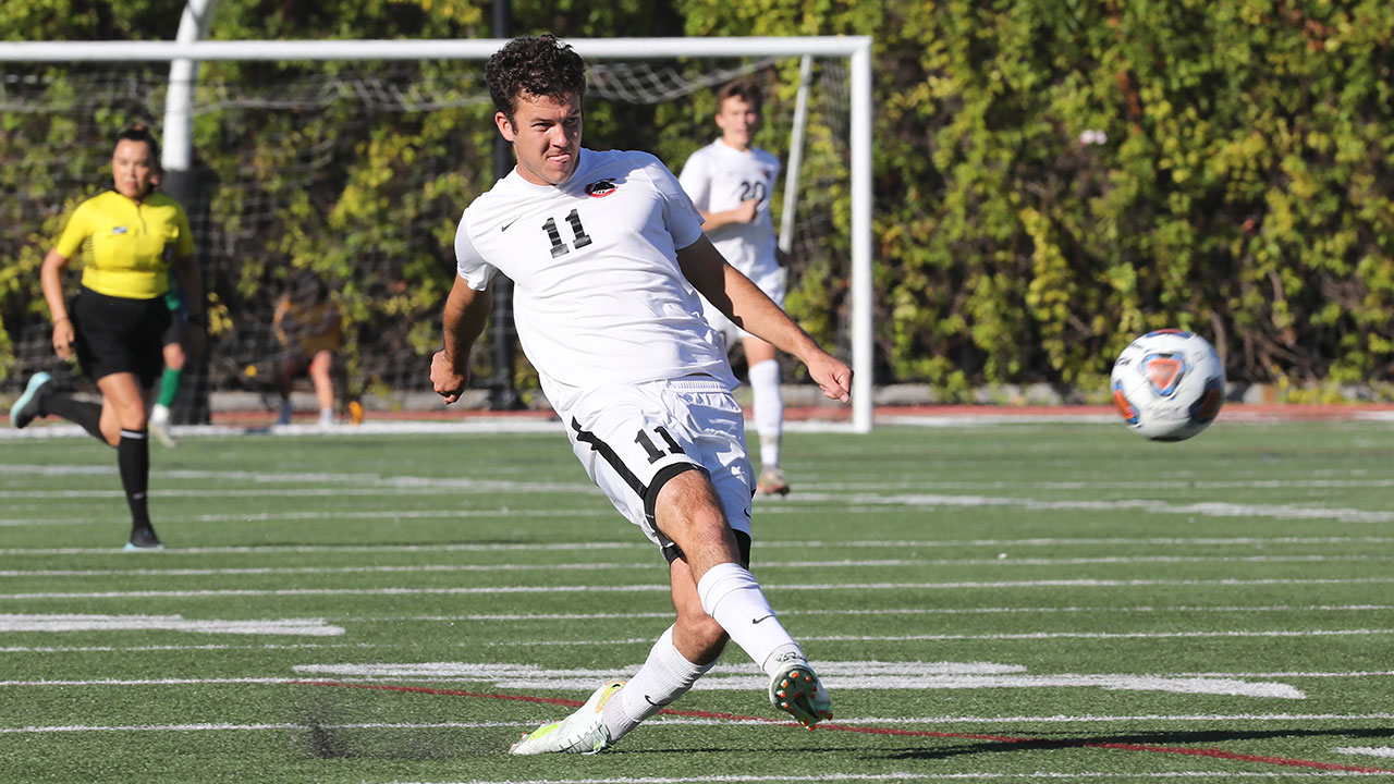 Aidan Wall takes a shot on the soccer field.