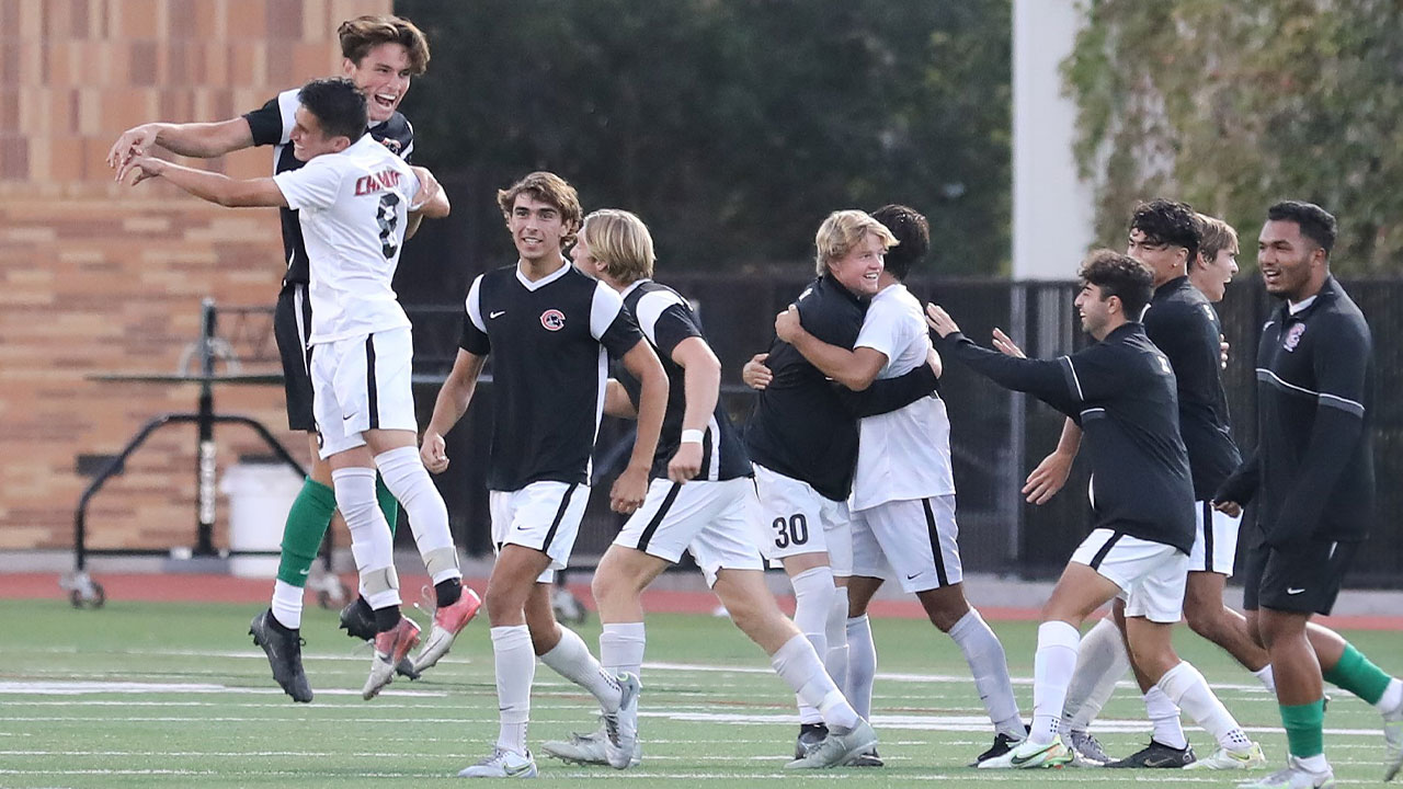 Chapman men's soccer players celebrating on the field.