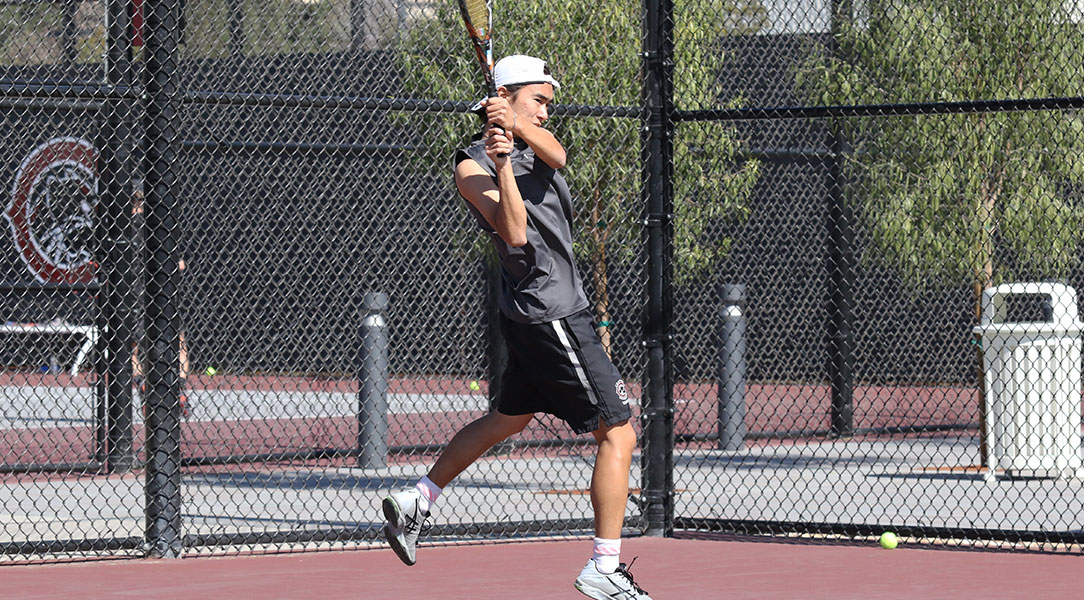 Len Kamemoto hits the ball.