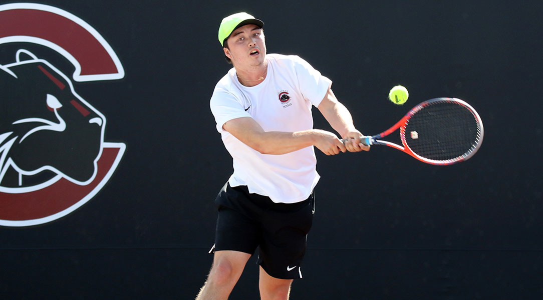 Matthew Mead  returns a backhand.
