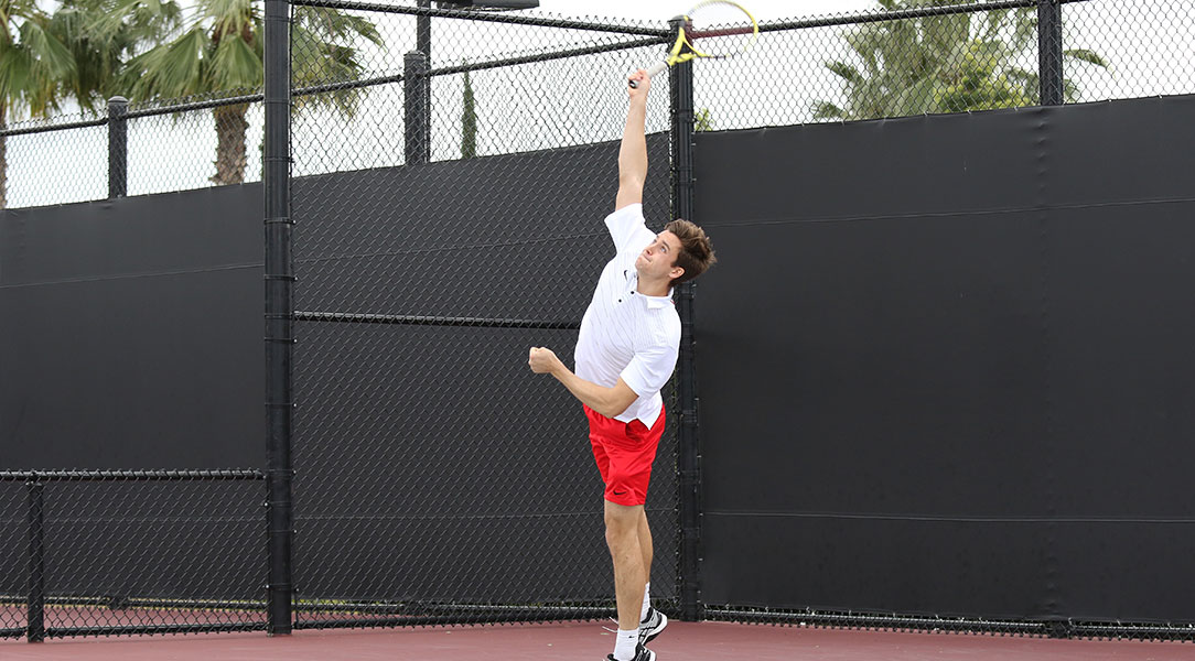 Brock DeHaven serves the ball.
