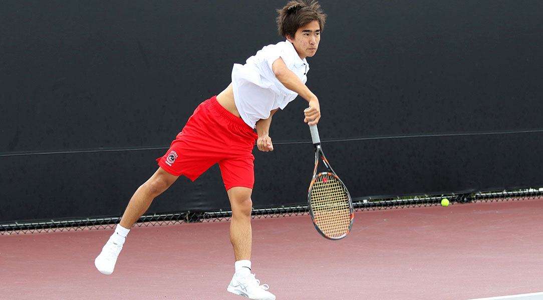 Len Kamemoto serves the ball.