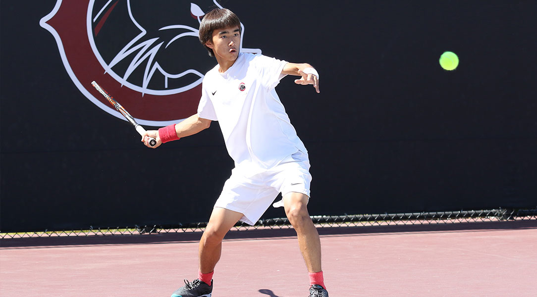 Len Kamemoto prepares to hit the ball.