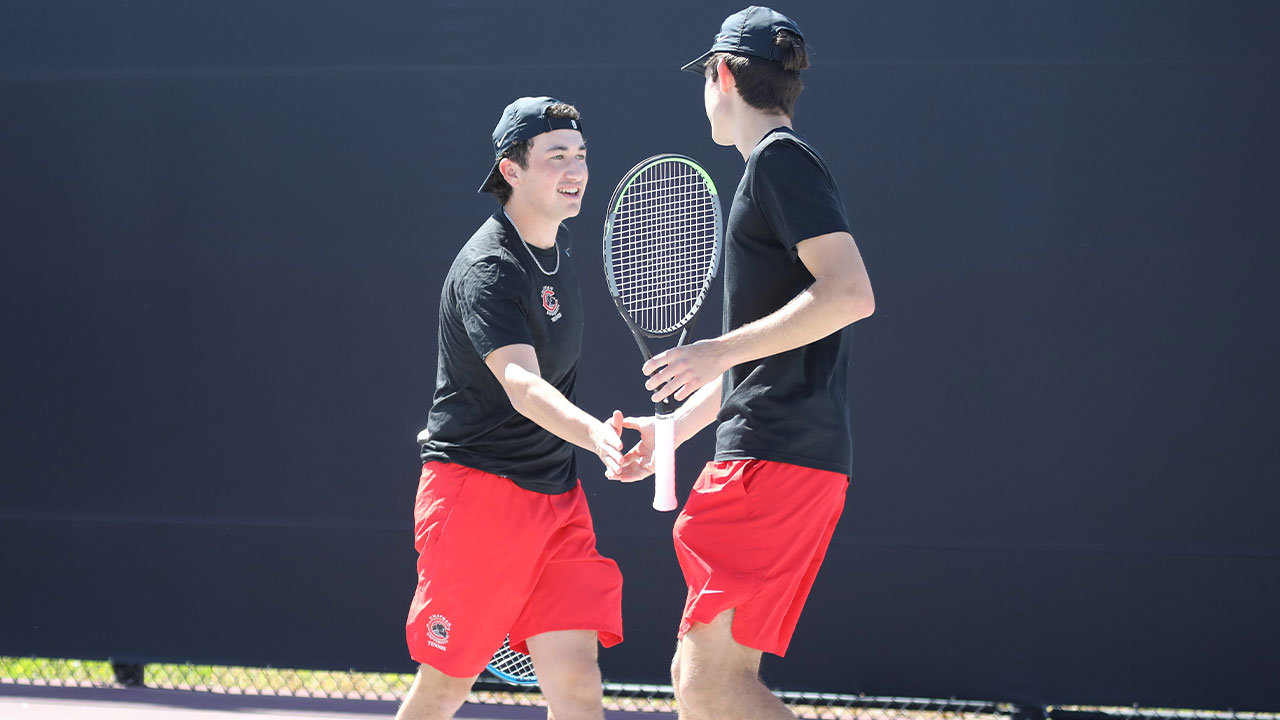 Danny Marsh gives his teammate a high five after winning a point.