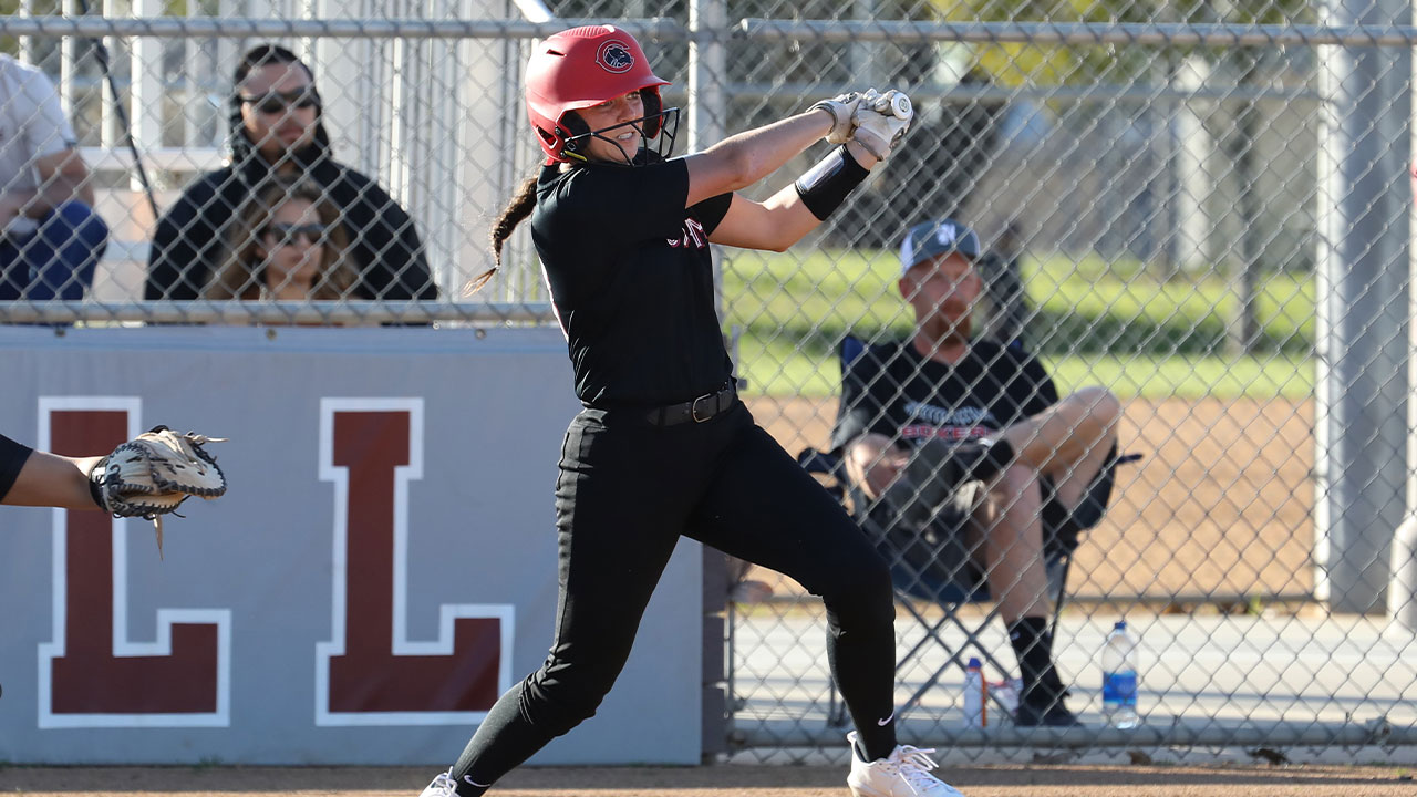 Grace Fosselman swings and hits a single in softball.