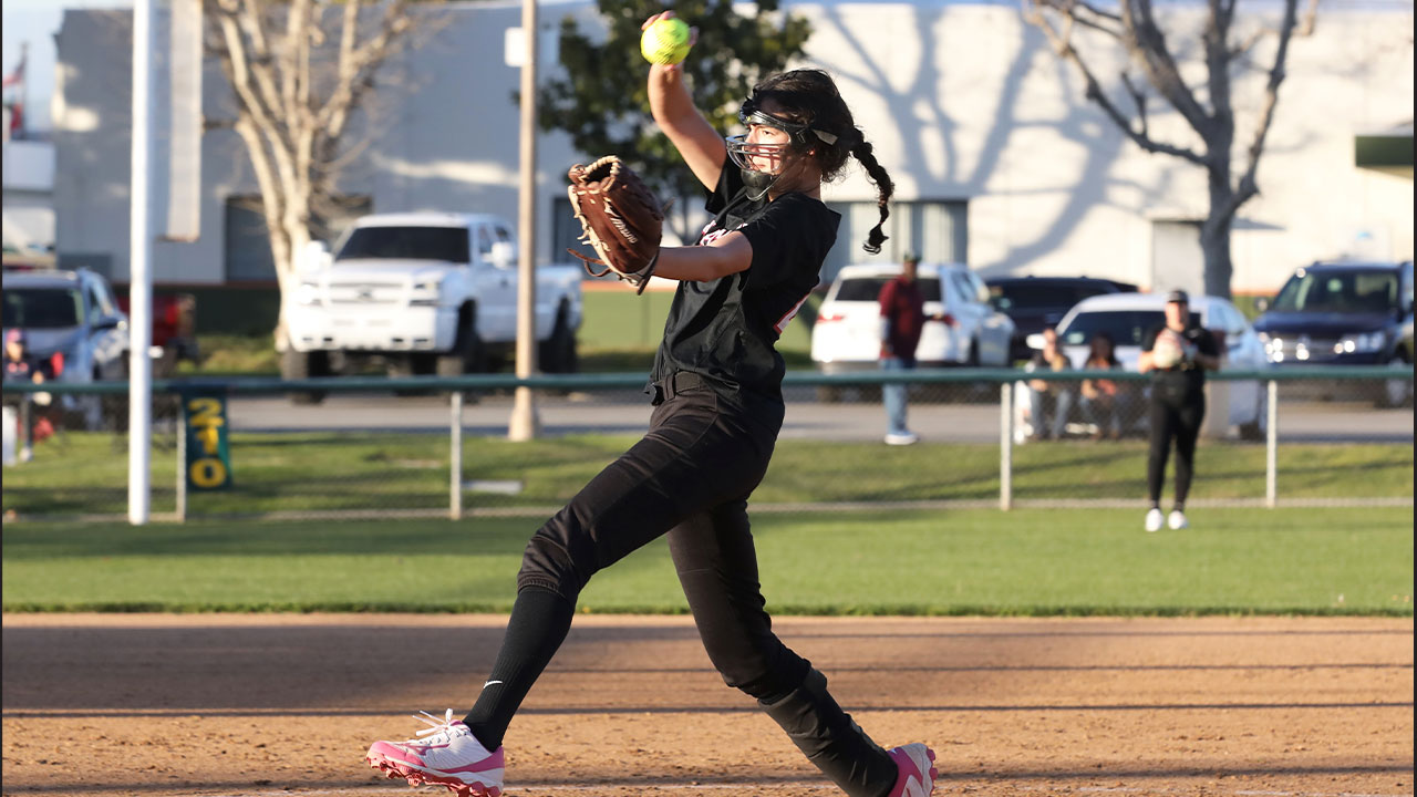 Simi Lauwers winds up to deliver a softball pitch.