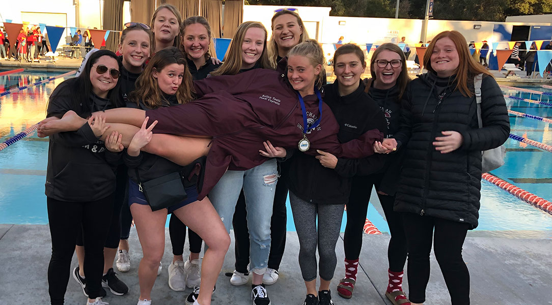 Kellyn Toole's teammates hold her up.