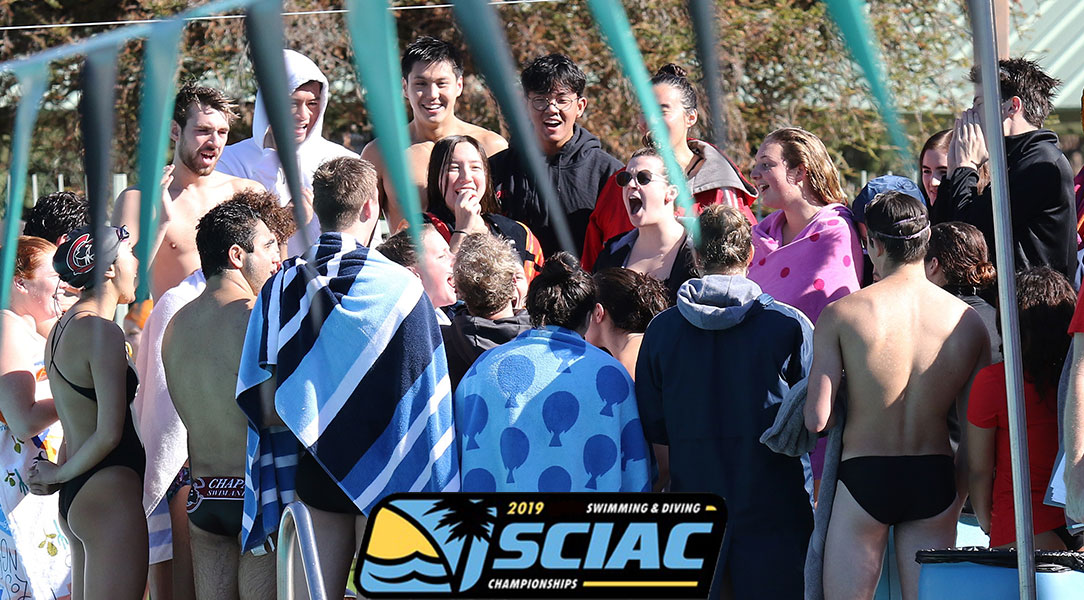 The swim and dive team does a cheer before the meet.