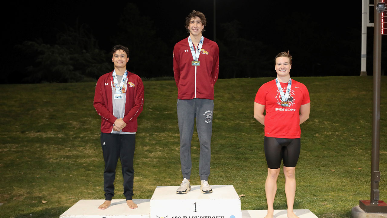 The top three finishers on the podium for the 100 back.