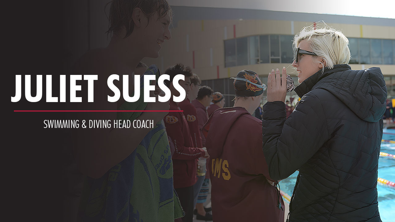 Juliet Suess talks to a swimmer.