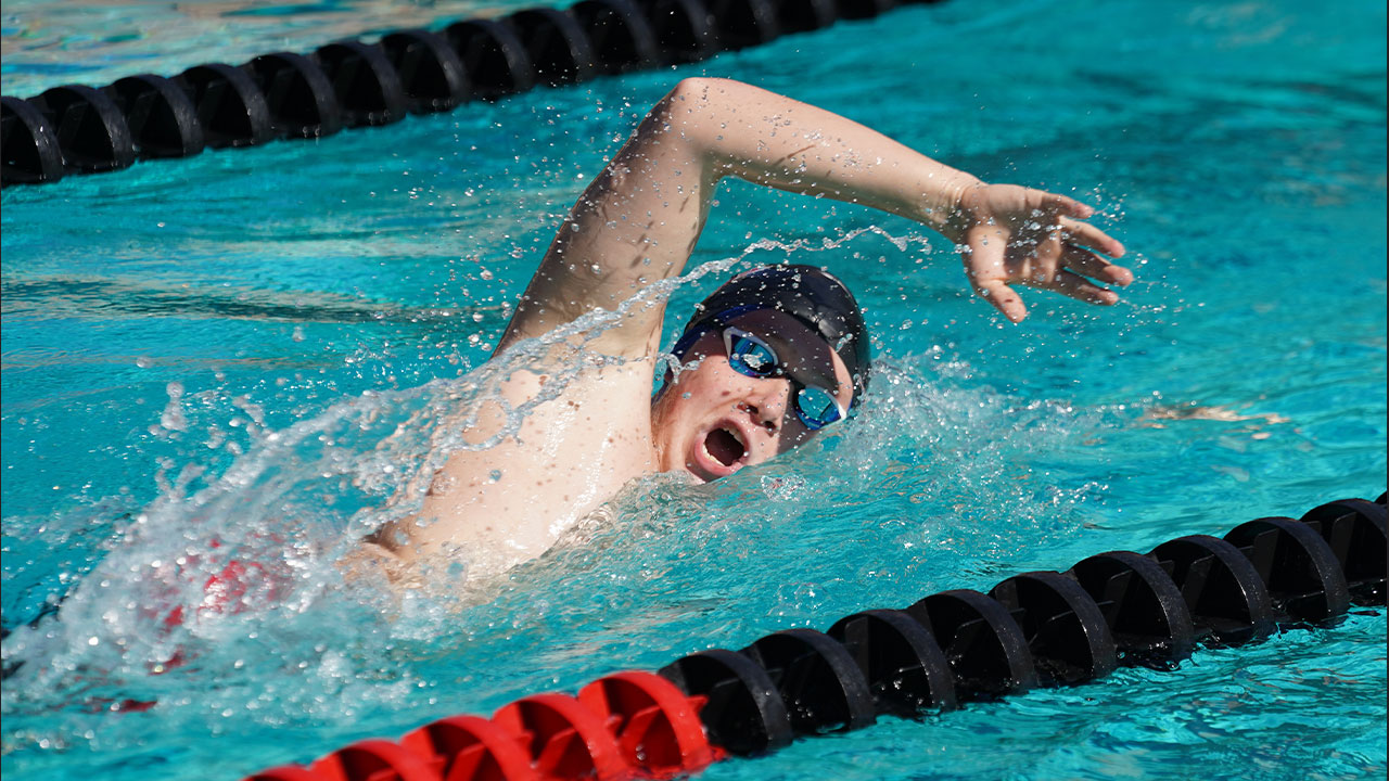 Man swimming freestyle.