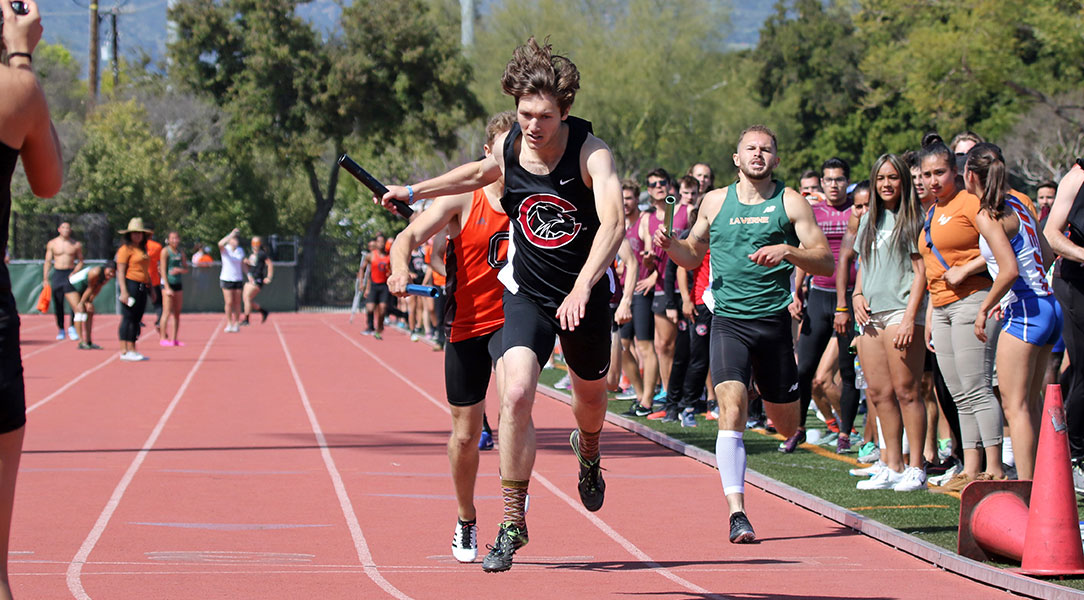 Scott Fitzpatrick stretches out across the finish line to take first place.