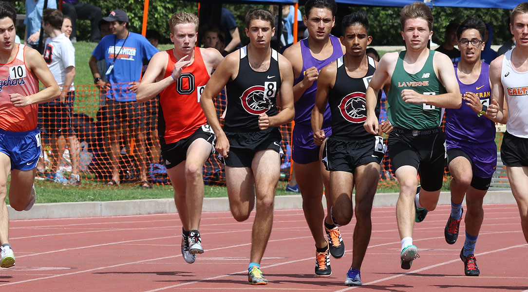 Male runners run down the track.