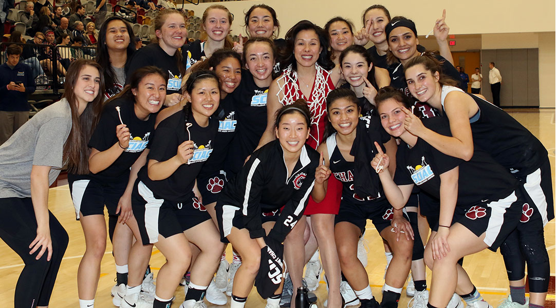 The team poses for a picture after cutting down the nets.