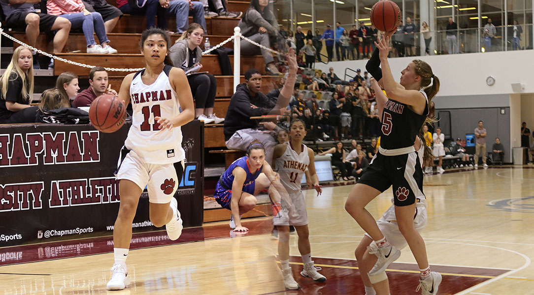 Jaryn Fajardo dribbles, Lucy Criswell shoots a layup.