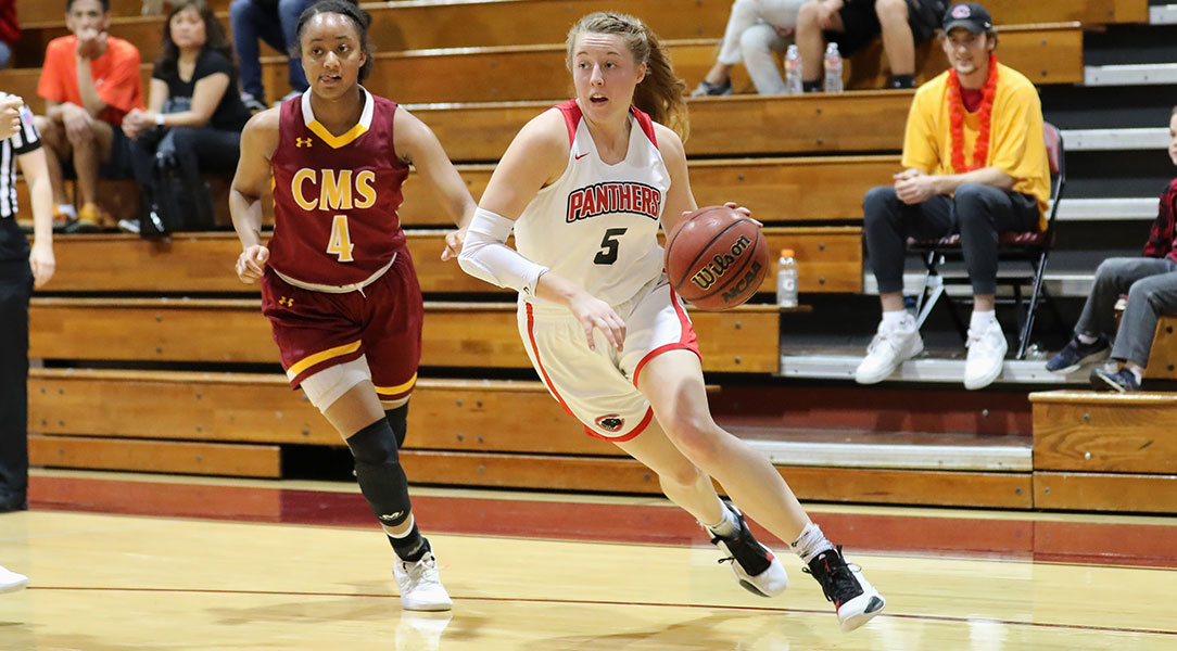 Lucy Criswell dribbles around a defender.