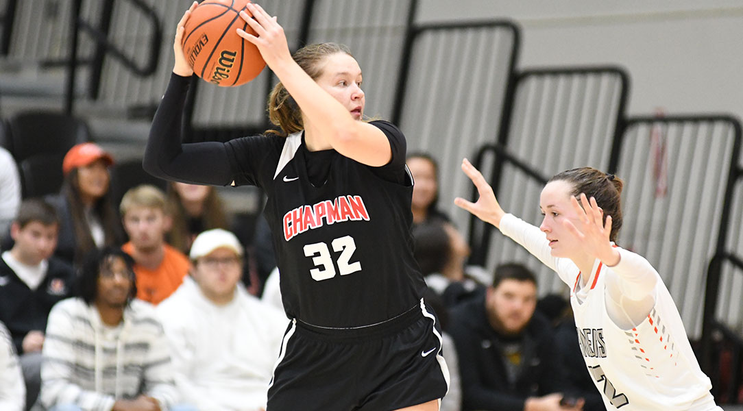 Taylor Hextrum holds the ball away from a defender.
