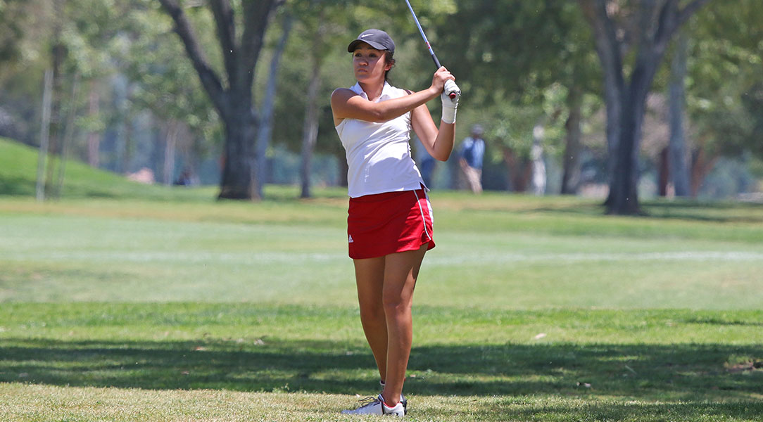 Emily Lewis watches her shot from the fairway.