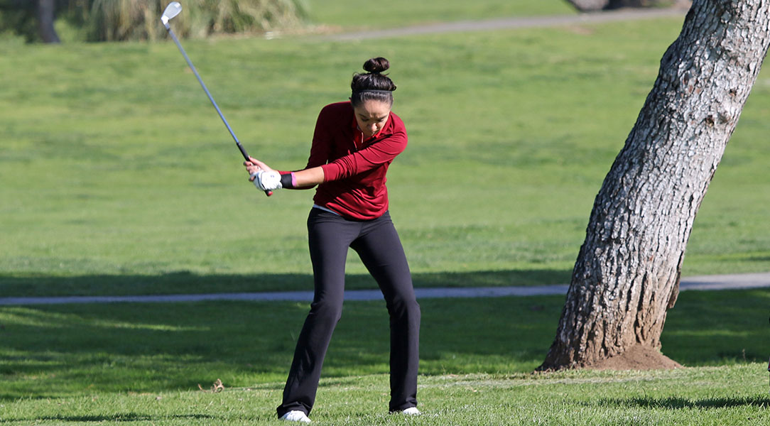 Emily Lewis swings the club.