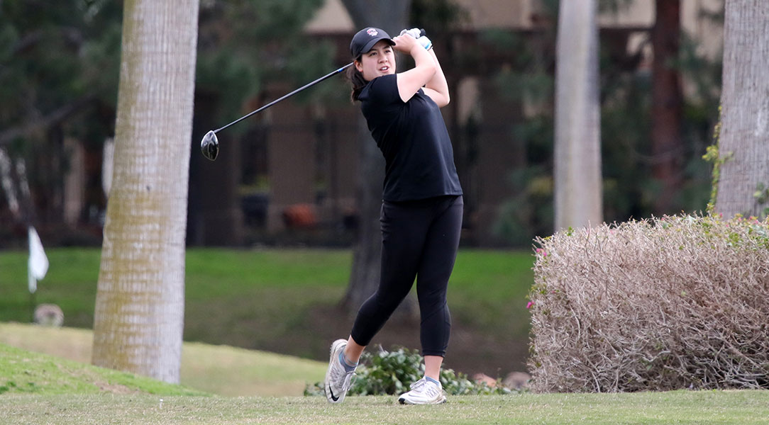 Kristen Lee watches her drive.