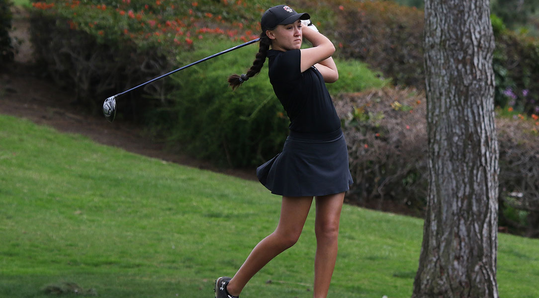 Emily Lewis finishes her swing.