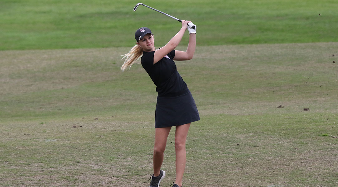 Lauren Settle watches a shot from the fairway.